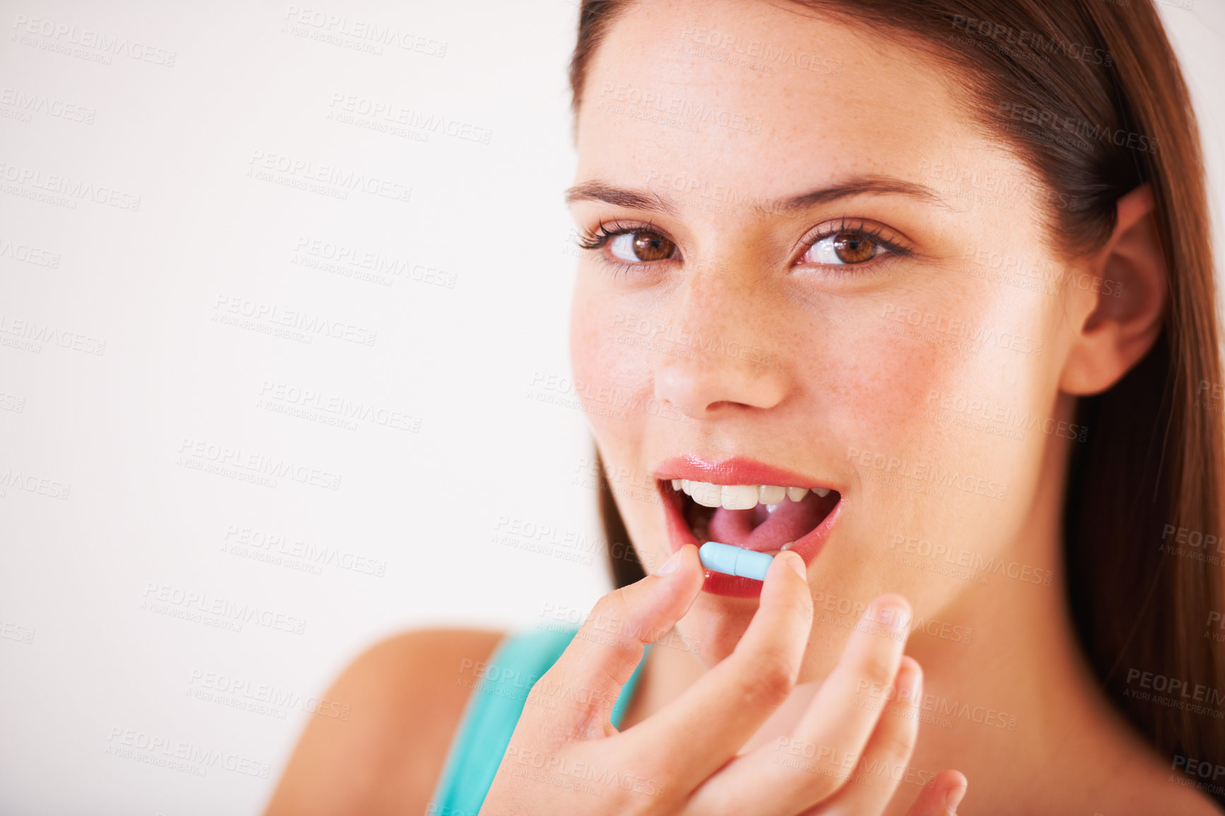 Buy stock photo Portrait of a beautfiul young woman about to take a tablet