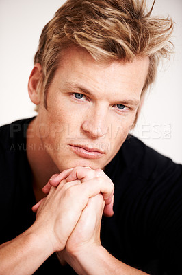 Buy stock photo Portrait, fashion and a confident man in studio isolated on a gray background for trendy style closeup. Face, beauty and hair with a young model looking serious in a edgy clothes or stylish outfit