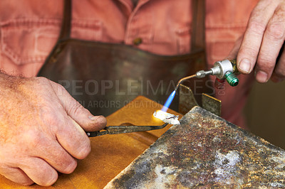 Buy stock photo Cropped view of a manufacturing jeweler at work with a small acetylene torch