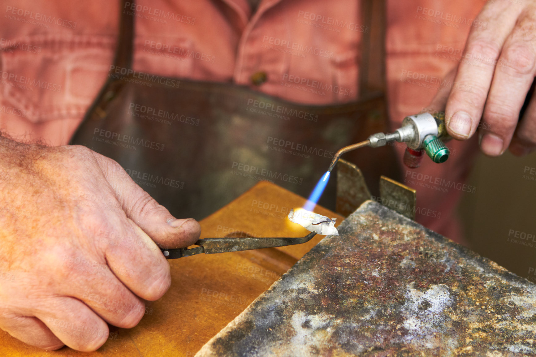 Buy stock photo Cropped view of a manufacturing jeweler at work with a small acetylene torch