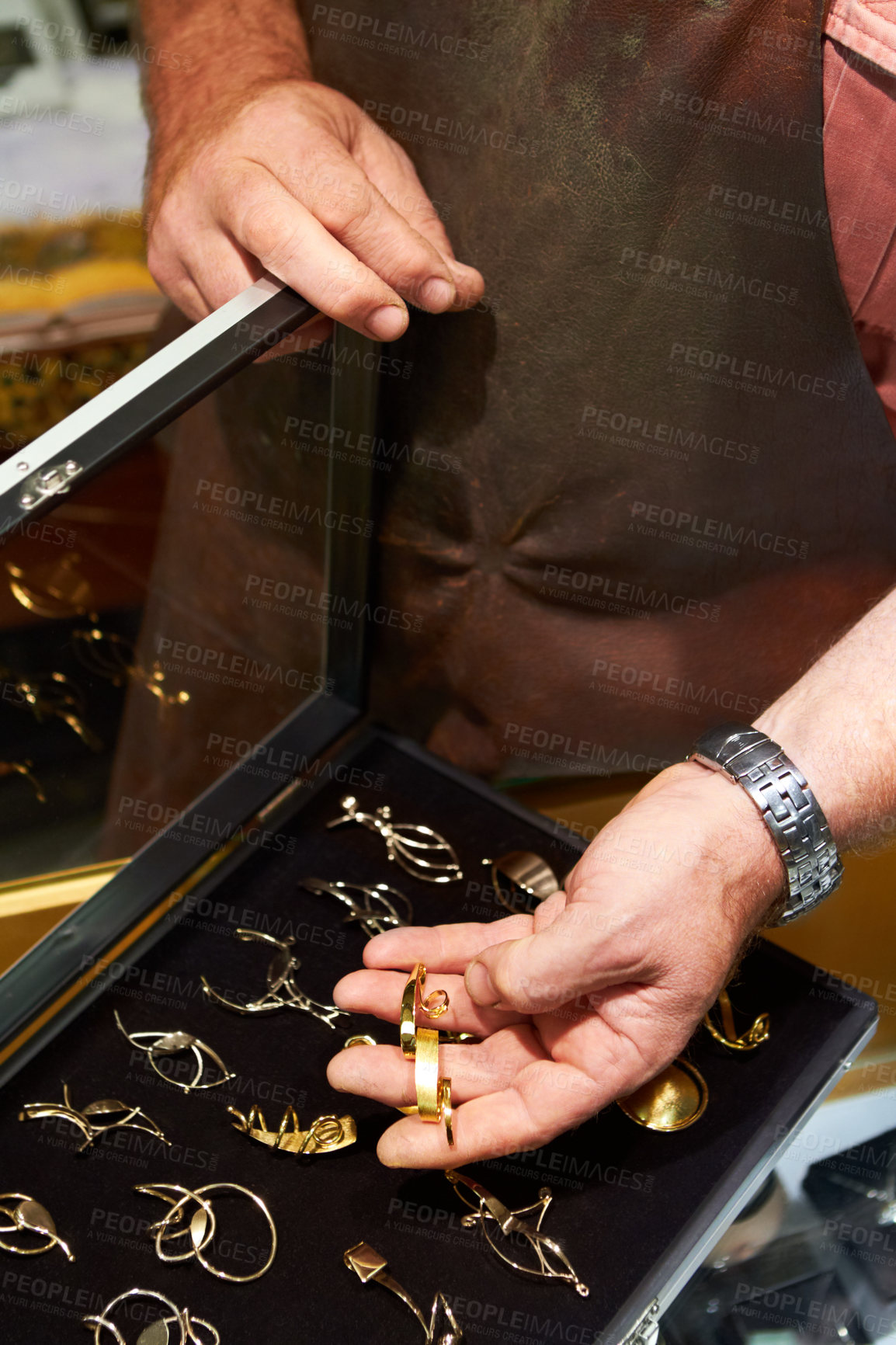 Buy stock photo Cropped view of a jeweler showing his handiwork