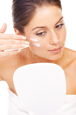 Buy stock photo Woman, face and mirror with cream for skincare, moisturizer or spa treatment against a white studio background. Female person or model applying lotion, creme or facial cosmetics for skin wellness
