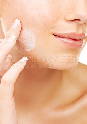Buy stock photo Woman, face and hand with cream in skincare, beauty or cosmetics against a studio background. Closeup of female person or model smile in satisfaction for lotion, creme or facial product and treatment