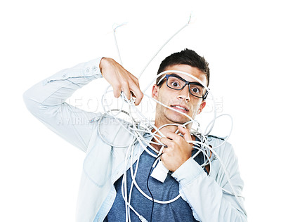 Buy stock photo Portrait of man in glasses tangled in wire, cables and isolated on a white background. Face of serious geek wrapped in cord and tech of nerd or electrician, mistake and problem, chaos or struggle
