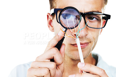 Buy stock photo Magnifying glass, technician and hand of man with cables or problem solving in white background. Studio, electrician or working with electricity, wires or search for solution or check for power