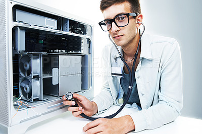 Buy stock photo Studio portrait of a young man working on a computer hard drive