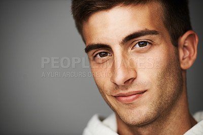 Buy stock photo Portrait, man and closeup for fashion in studio for mock up in cool, casual and style on gray background. Male model, person or student with facial expression with confidence with hoodie in Spain