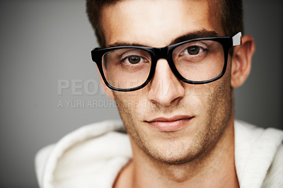 Buy stock photo Closeup, portrait and man with glasses in studio for eye care mock up on gray background in Spain. Male model, person and vision with facial expression for spectacles by correction, lens or sight