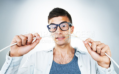 Buy stock photo IT support, cable and power with an electrician man in studio on a gray background for troubleshooting. Face, hands and glasses with an engineering nerd or technician connecting wires for internet