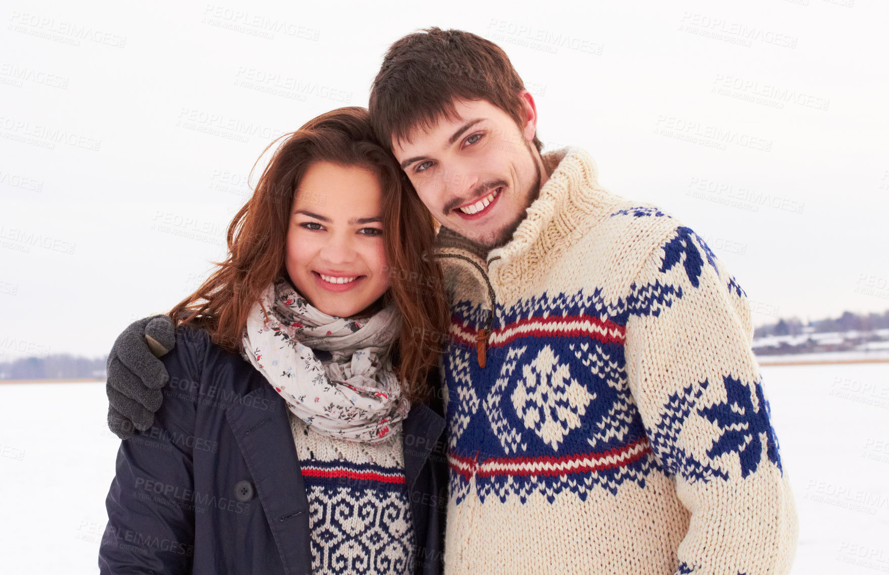 Buy stock photo Shot of a sweet young couple outdoors in the snow