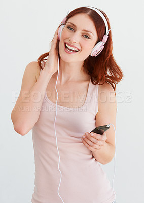 Buy stock photo Woman, headphones and smile in portrait for music, streaming and happiness by wall background. Girl, student or isolated model with smartphone for audio app, sound and internet radio with listening