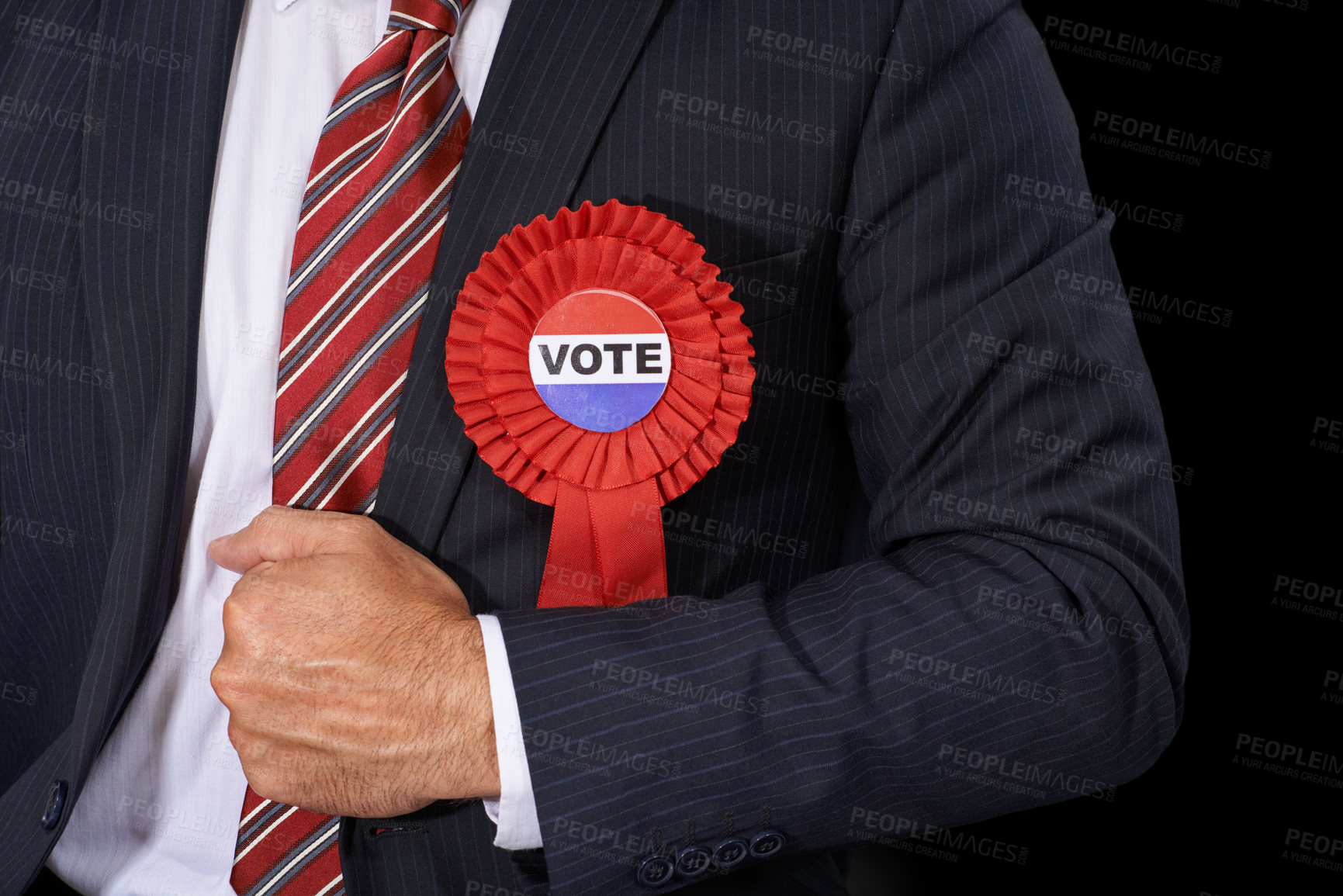 Buy stock photo Cropped view of a man in a suit wearing a voting ribbon ona black background