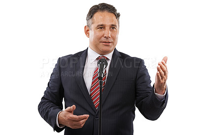Buy stock photo A man in a suit with his hands raised while saying a speech into a microphone