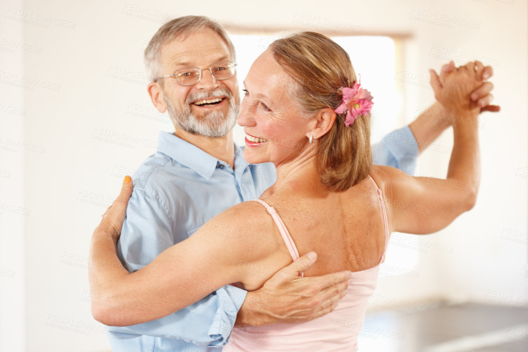 Buy stock photo Senior couple, dancing and happiness in home, love and ballroom for fun, touch and romantic. Retirement, bonding together and smile for husband, wife and quality time with tango, retired or elderly
