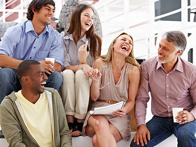 Buy stock photo A team of designers laughing at their colleague's joke