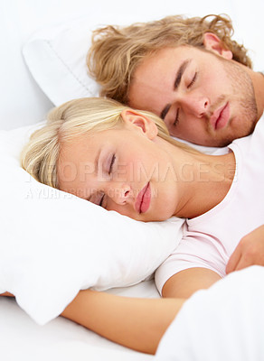 Buy stock photo Love, relax and a couple sleeping in bed in the morning in their home together for holiday or vacation. Face, dream or eyes closed to rest with a young woman and man in the bedroom of their apartment
