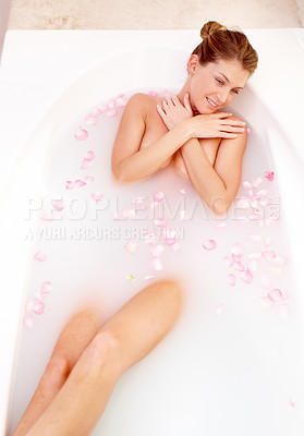 Buy stock photo Woman, rose and milk bath with flower petals and luxury bathroom treatment feeling calm. Body care, cleaning and female person relax in a home with floral aromatherapy and natural wellness wash