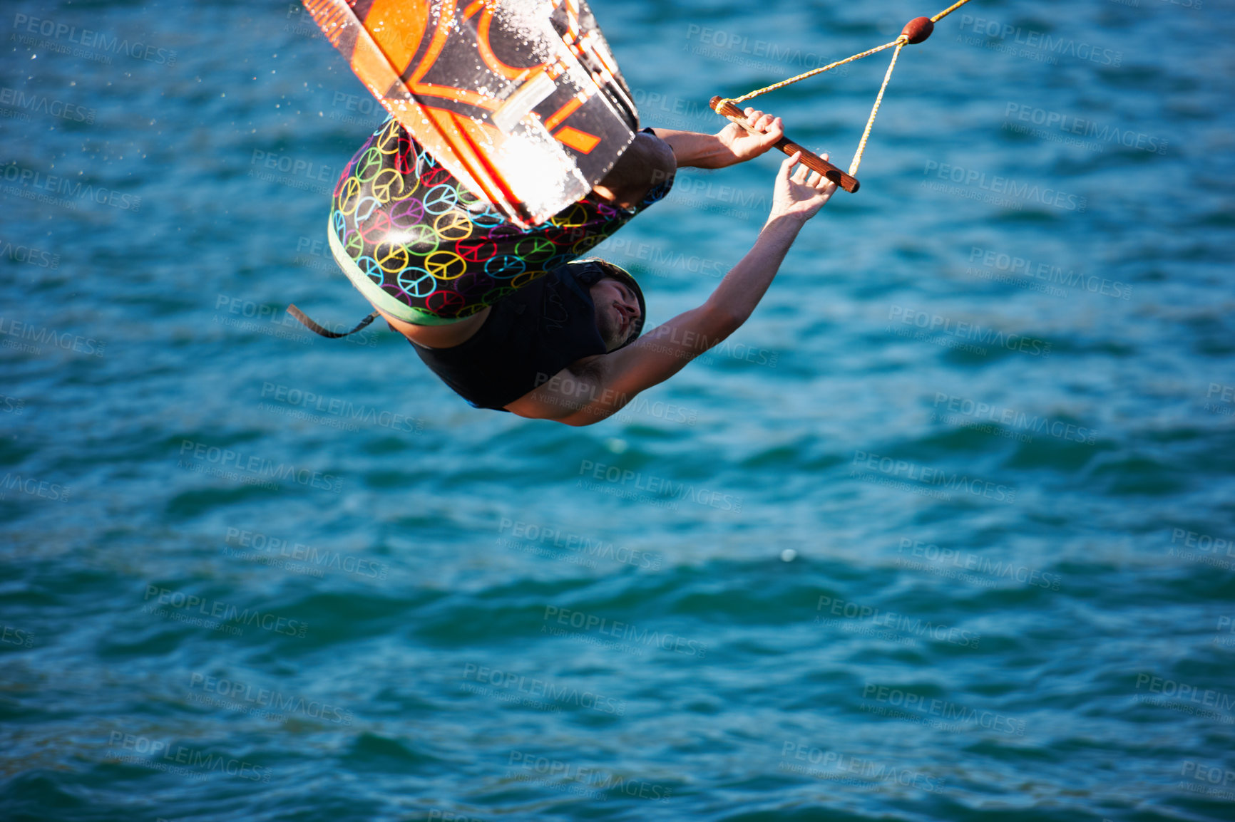 Buy stock photo Man, wakeboarding and ocean with jump, sport and fitness with speed on vacation in summer sunshine. Person, athlete and ski with rope for safety on lake, sea or river with training, exercise or waves