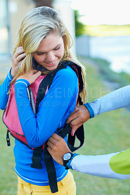 Buy stock photo Woman in life jacket for safety, ready for kayaking and adventure with sport outdoor. Young female person getting help with gear for protection, fitness in nature with exercise and active lifestyle