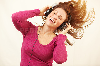 Buy stock photo Cropped shot of a happy young woman dancing while listening to music