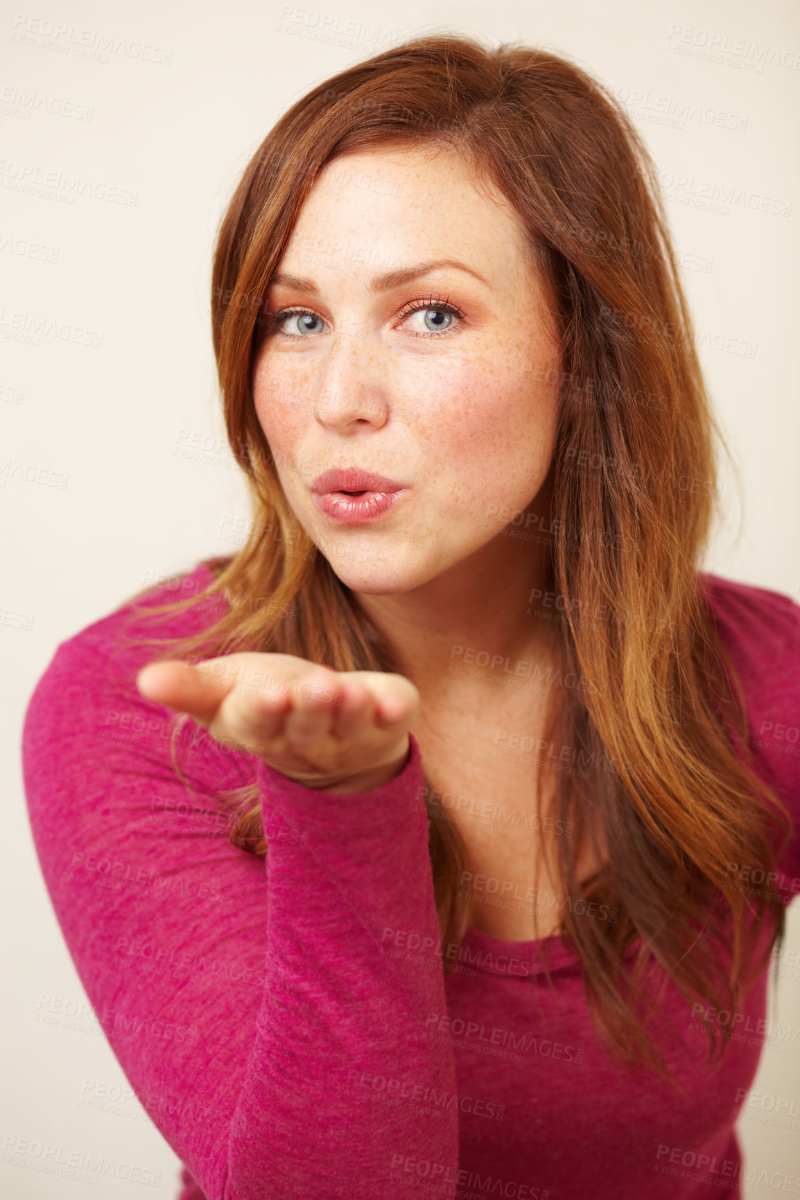 Buy stock photo Cropped shot of an attractive young woman blowing a kiss