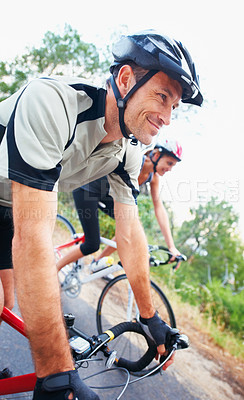 Buy stock photo Shot of two people enjoying a bicycle ride together