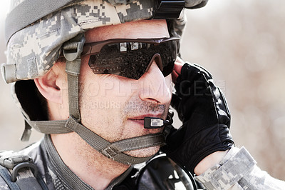 Buy stock photo Closeup profile of a soldier communicating on his headset