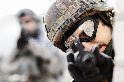 Buy stock photo Close up of a sniper with gun pointed at the camera and soldier in the background with copy space