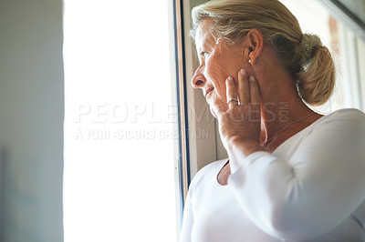 Buy stock photo Senior, woman and thinking at window for nostalgia for memory in retirement, thoughts in home. Old person, female and hand wondering at view loneliness as pensioner, aging alone or remembering life