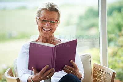 Buy stock photo Senior woman, home and book with reading, chair or relax in living room with smile for story, knowledge or glasses. Happy elderly lady, person and thinking in lounge in retirement with novel in house