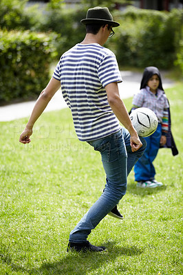 Buy stock photo Man, playing football with child in garden on grass, lawn or field with game or sport. Soccer, ball or kid with person training to kick or play on playground with fun exercise or activity together