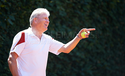 Buy stock photo Happy, senior man and game of tennis on court for exercise, workout and training in sport. Hand, pointing and mature person smile with energy, fitness and playing in healthy competition in retirement