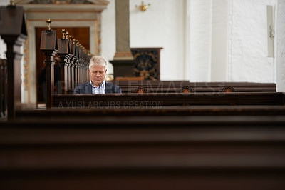 Buy stock photo A senior man sitting in the pews at his local church