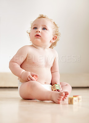 Buy stock photo Baby, boy and building blocks on a floor for learning, playing or having fun in a nursery room. Little, cute and curious kid relax with toy for child development, coordination or educational skills 