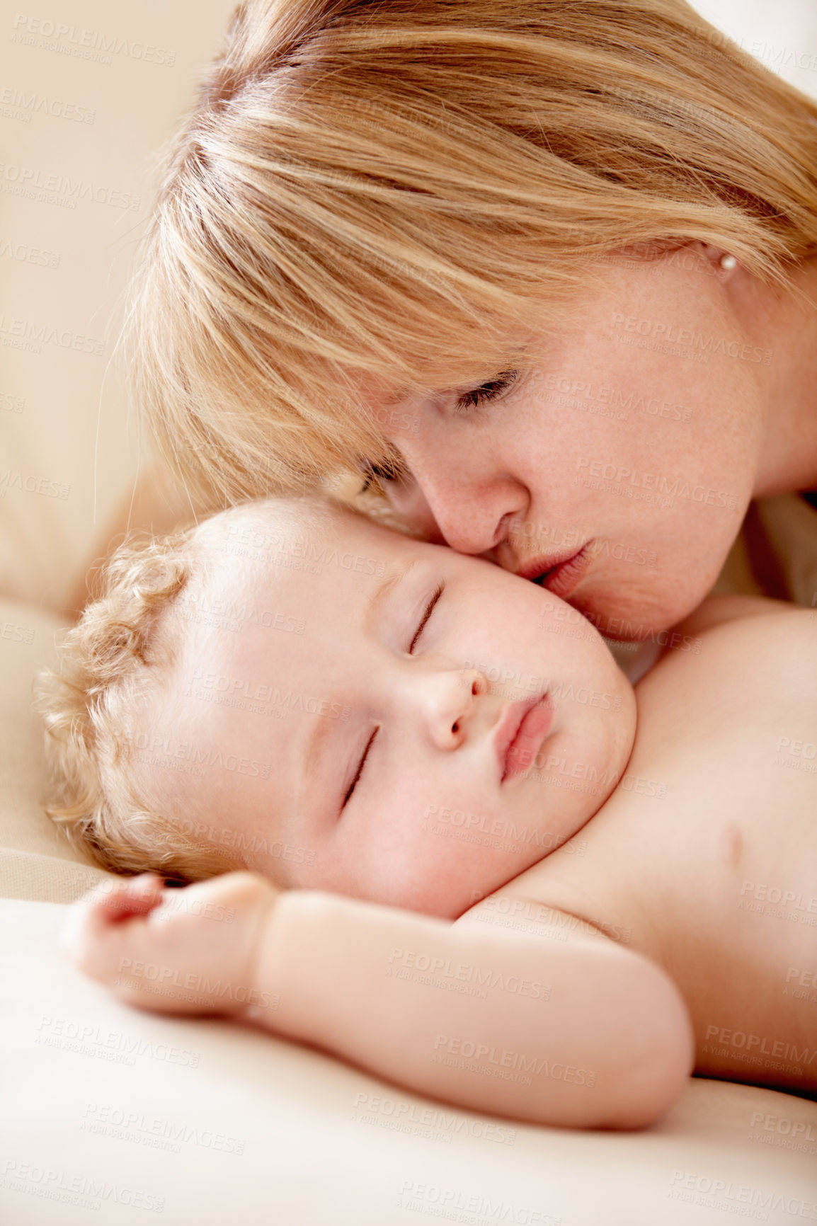 Buy stock photo Family, love and a mother kissing her baby closeup on a bed in their home for bonding together. Face, sleeping and an infant child in the bedroom of an apartment with his woman parent for affection