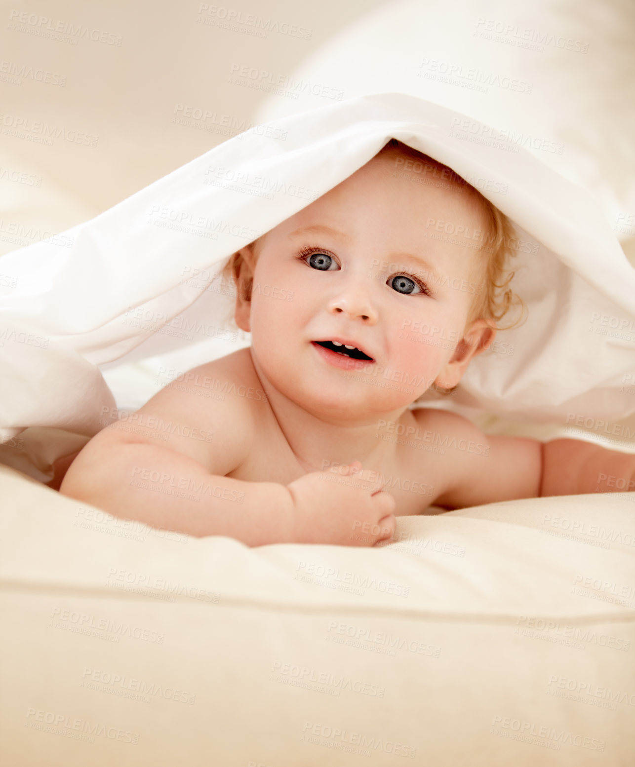 Buy stock photo Happy, face and baby on a bed with blanket for playing, games or fun in a nursery room. Learning, child development and curious boy kid in a bedroom with sheet cover while lying, resting or relax