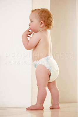 Buy stock photo Adorable baby boy standing by himself and looking away