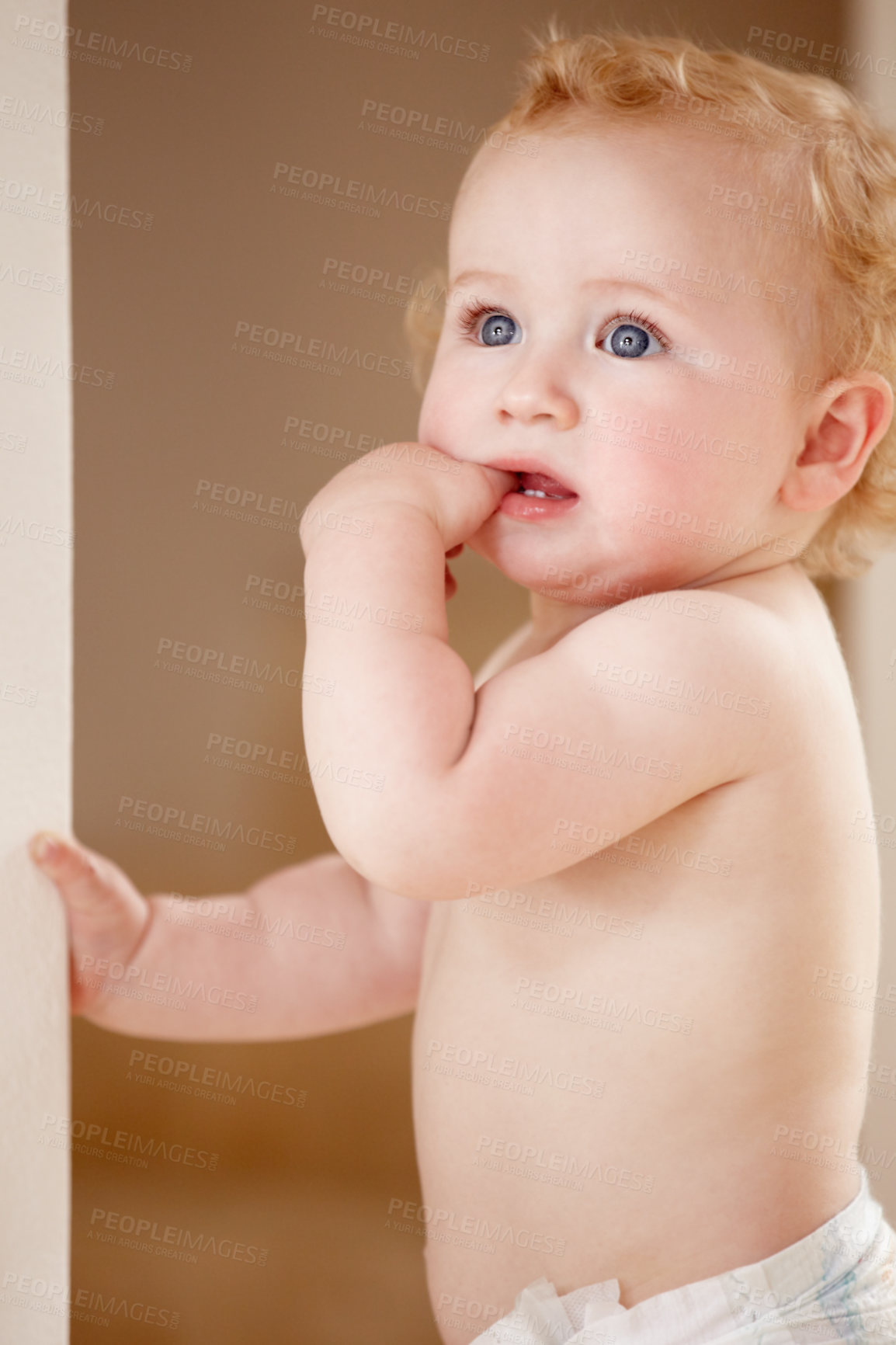 Buy stock photo Face, hands and baby in a room for playing, watching or fun, learning, walk or balance. Little, child development and curious boy kid in a nursery playful, standing and enjoy youth, freedom or games