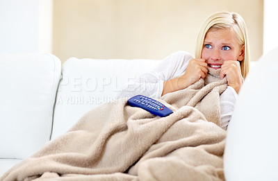 Buy stock photo Horror, fear and woman on sofa watching tv with remote, blanket and streaming movies in home. Terror, television and girl on couch in living room with shock for scary video, film or network show.