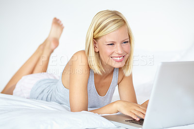 Buy stock photo A young woman working on her laptop from home