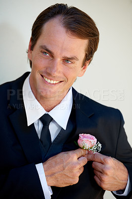 Buy stock photo Groom man, boutonniere and hands on suit for style with pride, smile and ready for wedding, party or celebration. Man, flowers or rose on tuxedo with thinking, preparation or happy for marriage event