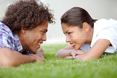 Buy stock photo Love, happy and couple on grass in garden lying together for bonding, relaxing and relationship. Dating, spring and face of man and woman for summer picnic on holiday, vacation and weekend on field