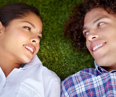 Buy stock photo Shot of a happy young couple gazing into each other&#039;s eyes on the lawn