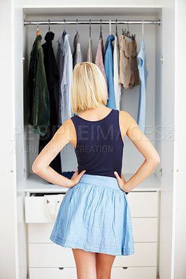 Buy stock photo Back, woman and wardrobe for clothes choice, fashion option and storage decision in home or house. Rear view, girl and closet for clothing, selection and person thinking of outfit at shelf in bedroom