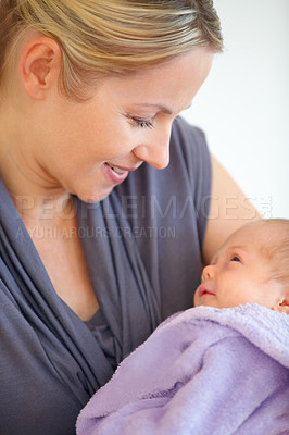 Buy stock photo Closeup, woman and holding of baby in home for love, care or bonding in relationship. Female person, motherhood and looking at child for hope, future or new life for development, milestone or growth
