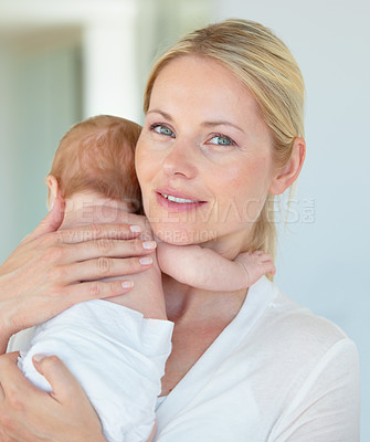 Buy stock photo Portrait of a mother cradling her newborn baby over her shoulder