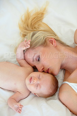 Buy stock photo Relax, kiss and bed, mom and baby bonding, woman and kid lying in home together. Calm morning, mother and newborn in bedroom for rest, love and happy family support, comfort and child care from above
