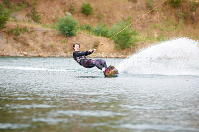 Buy stock photo Sporty young guy out wakeboarding on the lake