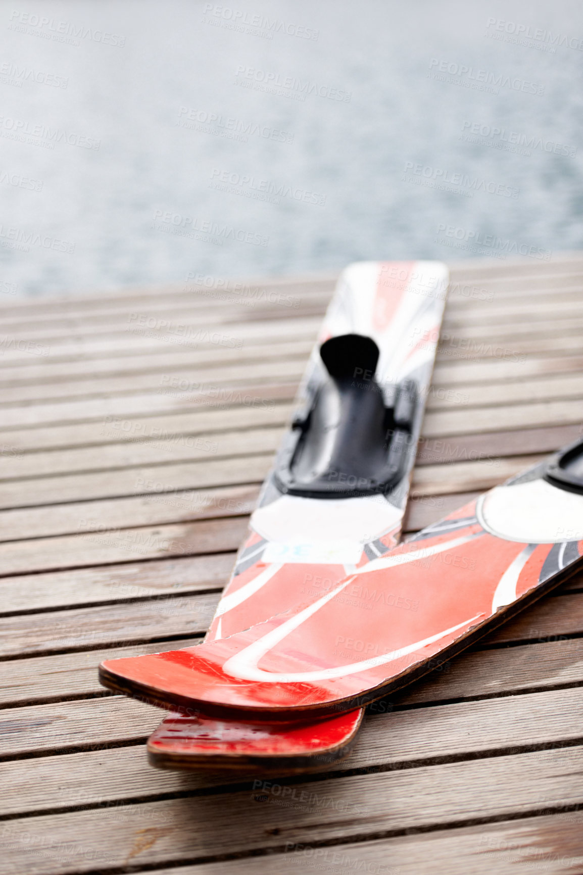 Buy stock photo Cropped view of a pair of skis alongside the lake