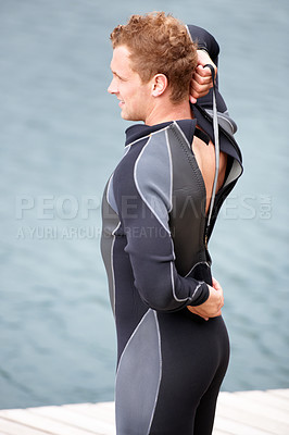 Buy stock photo Man, ready and wetsuit at lake, outdoor and extreme sports for fitness, exercise and workout. Person, swimsuit and thinking by river, nature and safety with ideas, health and start summer training